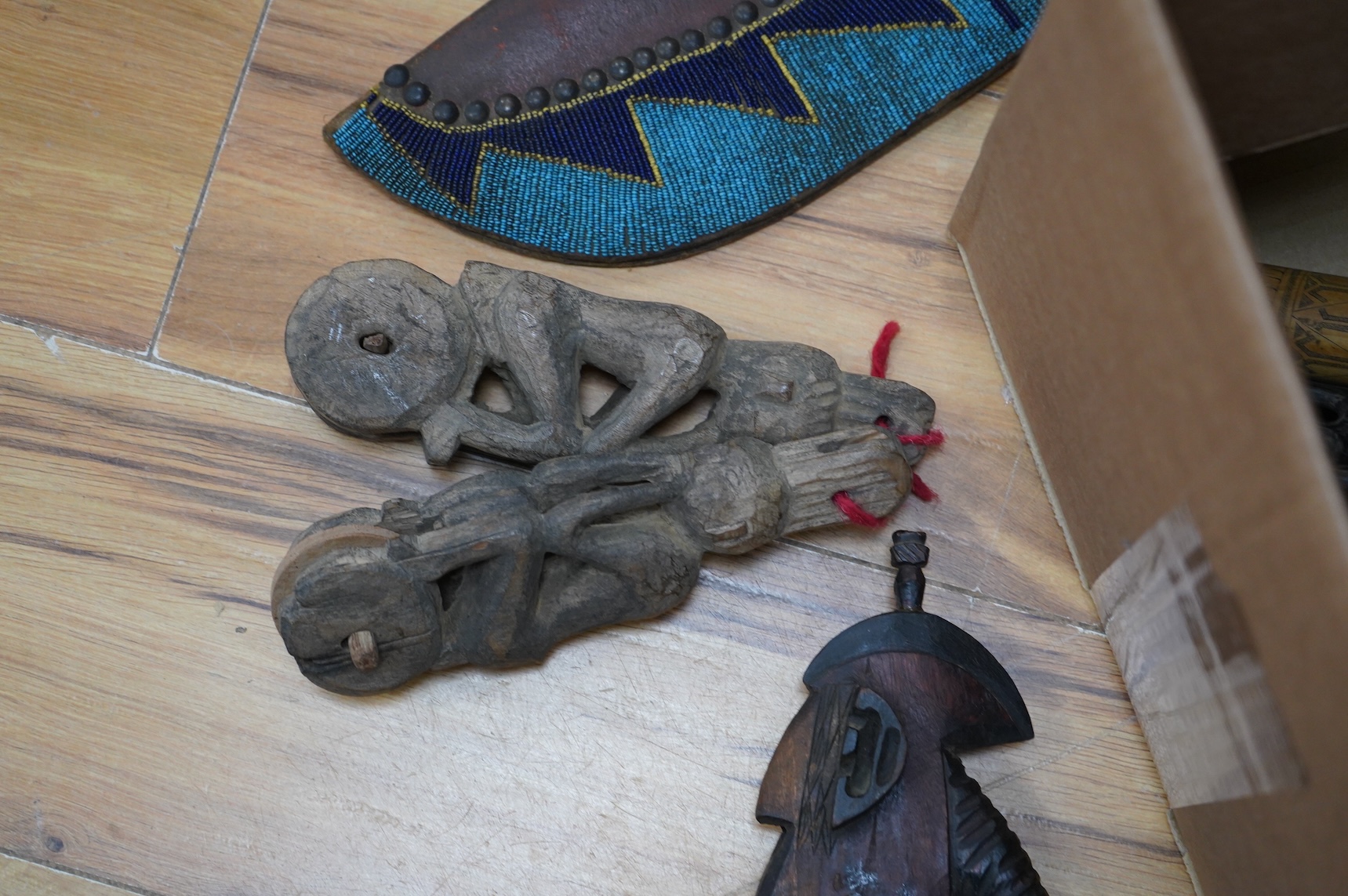 A collection of Burmese items to include wood weaving block, two figural weaving pulleys, two arrow heads and two trunk pots